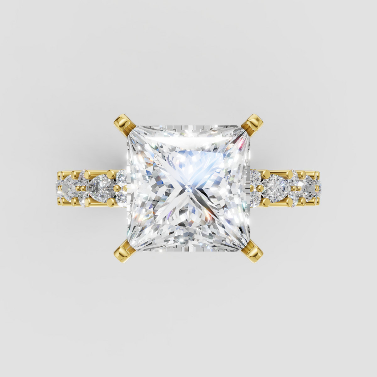 Princess cut diamond four-prong engagement ring with yellow gold band and side stones
